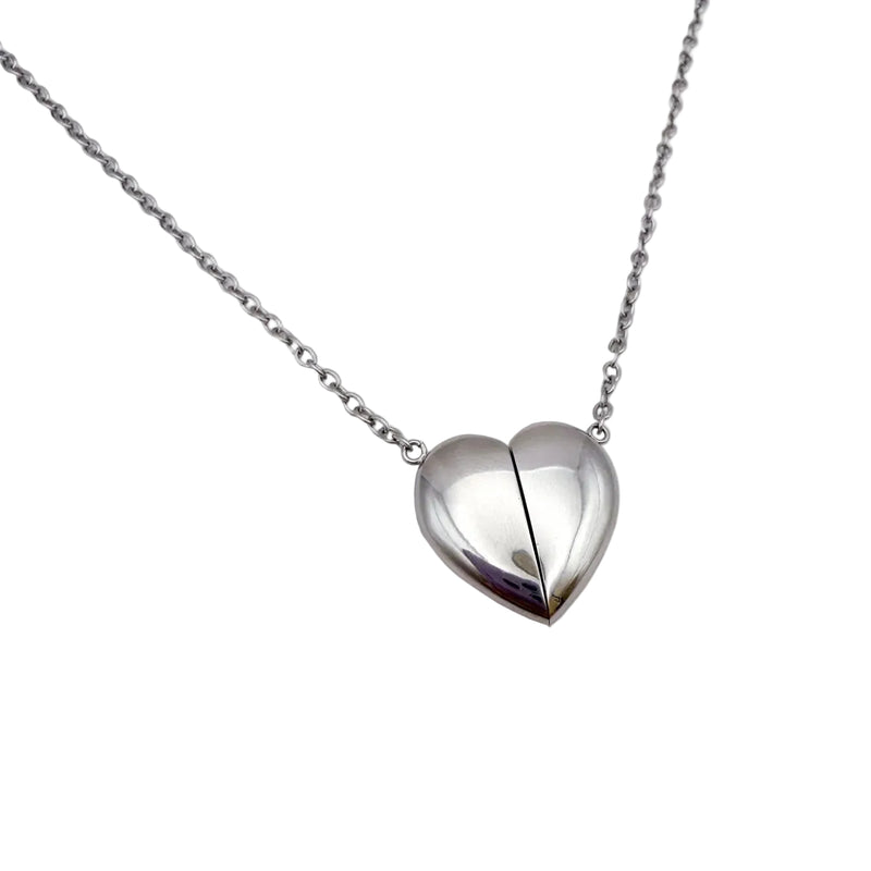 A silver fidget heart-shaped pendant necklace on a delicate silver chain, displayed against a clean white background.