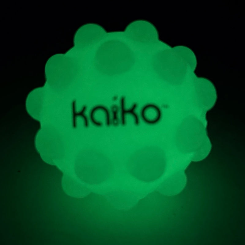 Kaiko Pop It Squishy Ball glowing green in the dark
