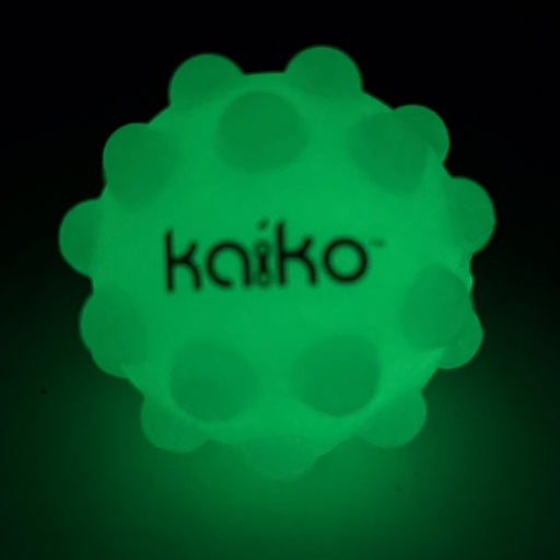 Kaiko Pop It Squishy Ball glowing green in the dark