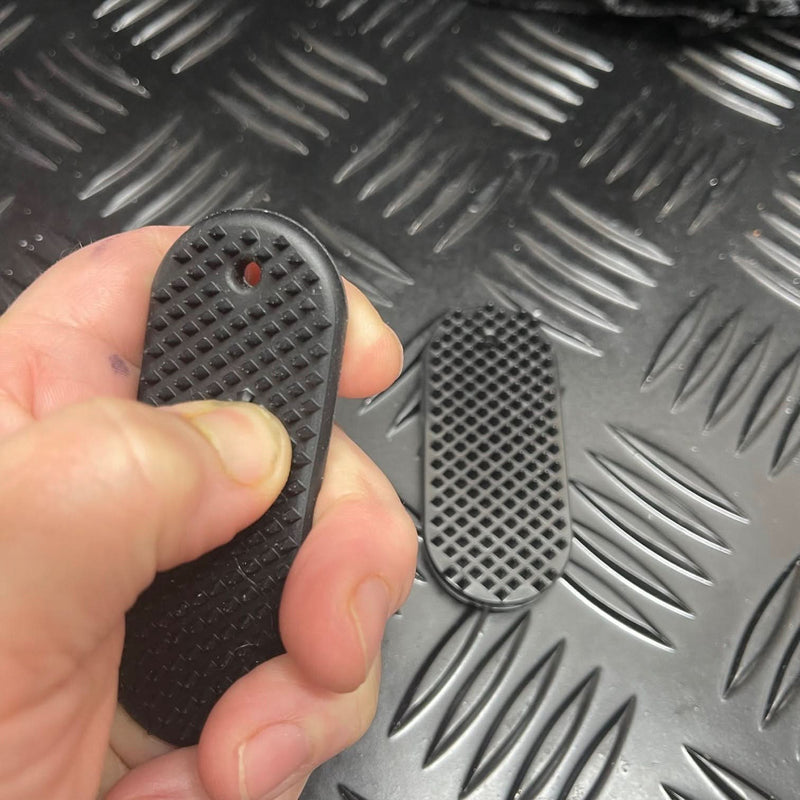 Hand squeezing firm PVC Kaiko SpiKEYring pad for focused sensory pressure