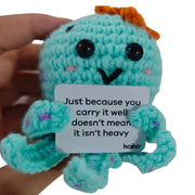 Just Because You Carry It Well octopus crochet critter held in hand for size reference