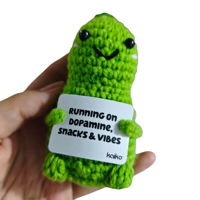 Green dinosaur crochet critter held in hand