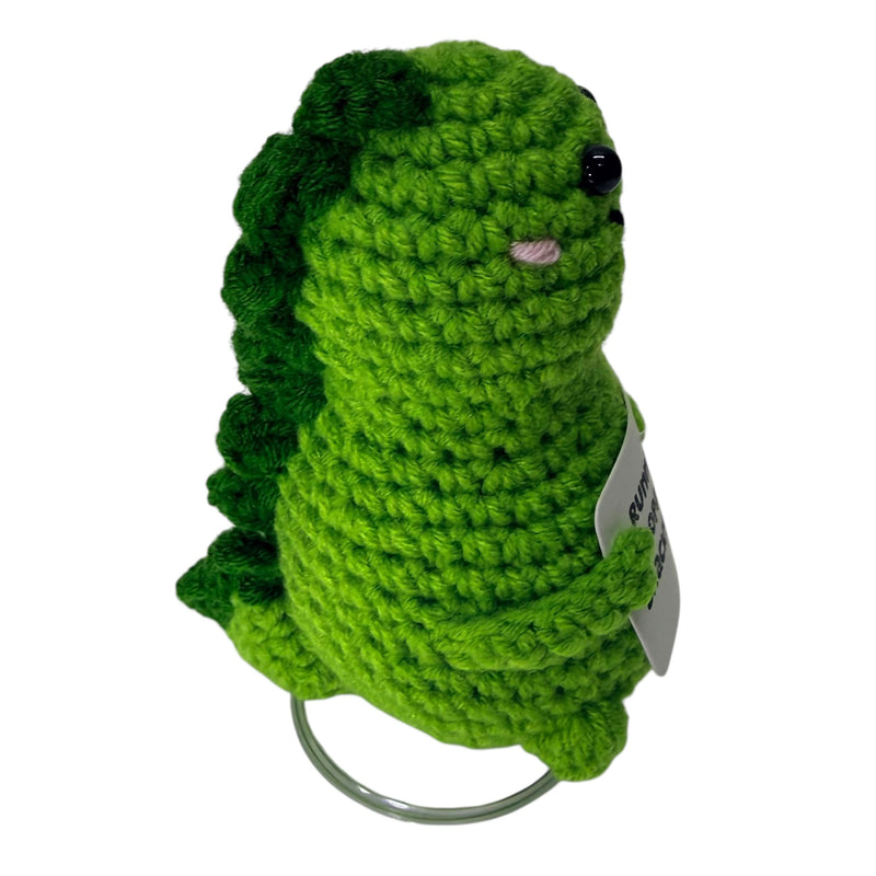Side view of green dinosaur crochet critter