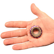 Freewheel Spinner resting in an adult hand for scale