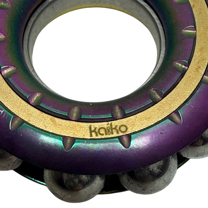 Close-up of Kaiko branding and electroplated oil slick finish