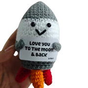 Love You to the Moon and Back rocket crochet critter held in hand for size reference