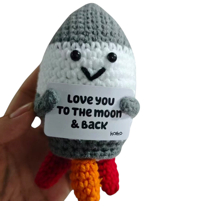 Love You to the Moon and Back rocket crochet critter held in hand for size reference