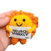 Neuro Sparkly sunshine crochet critter held in hand for size reference
