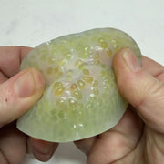 Green Vivid Stretchy Pick 'Em close-up in hand