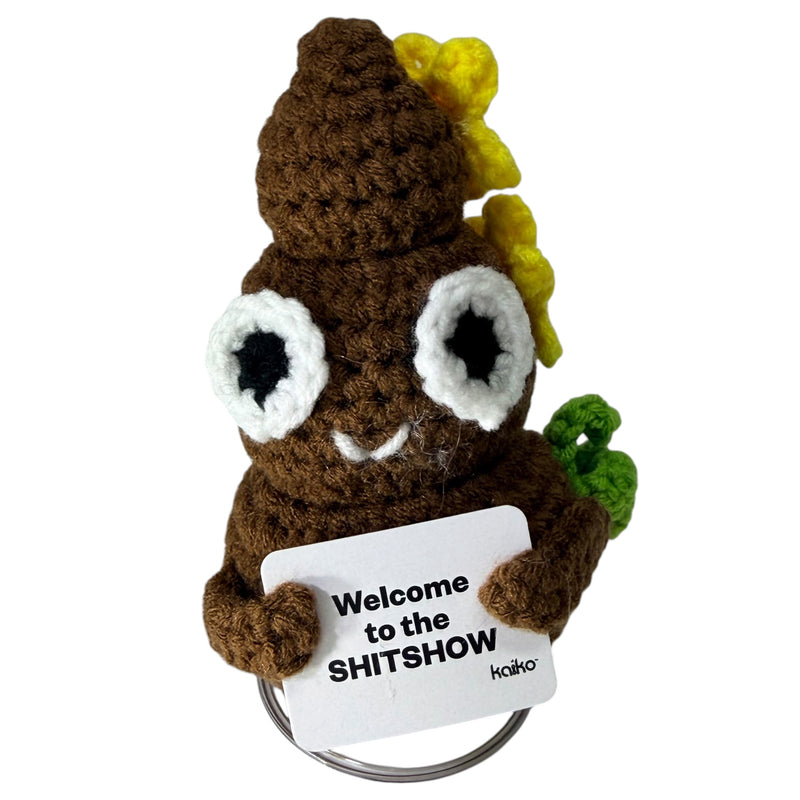 Front-facing Welcome to the SHITSHOW brown poo crochet critter with flowers and message