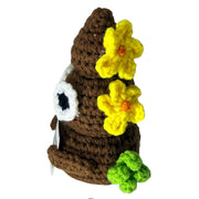 Side view of Welcome to the SHITSHOW brown poo crochet critter with flowers
